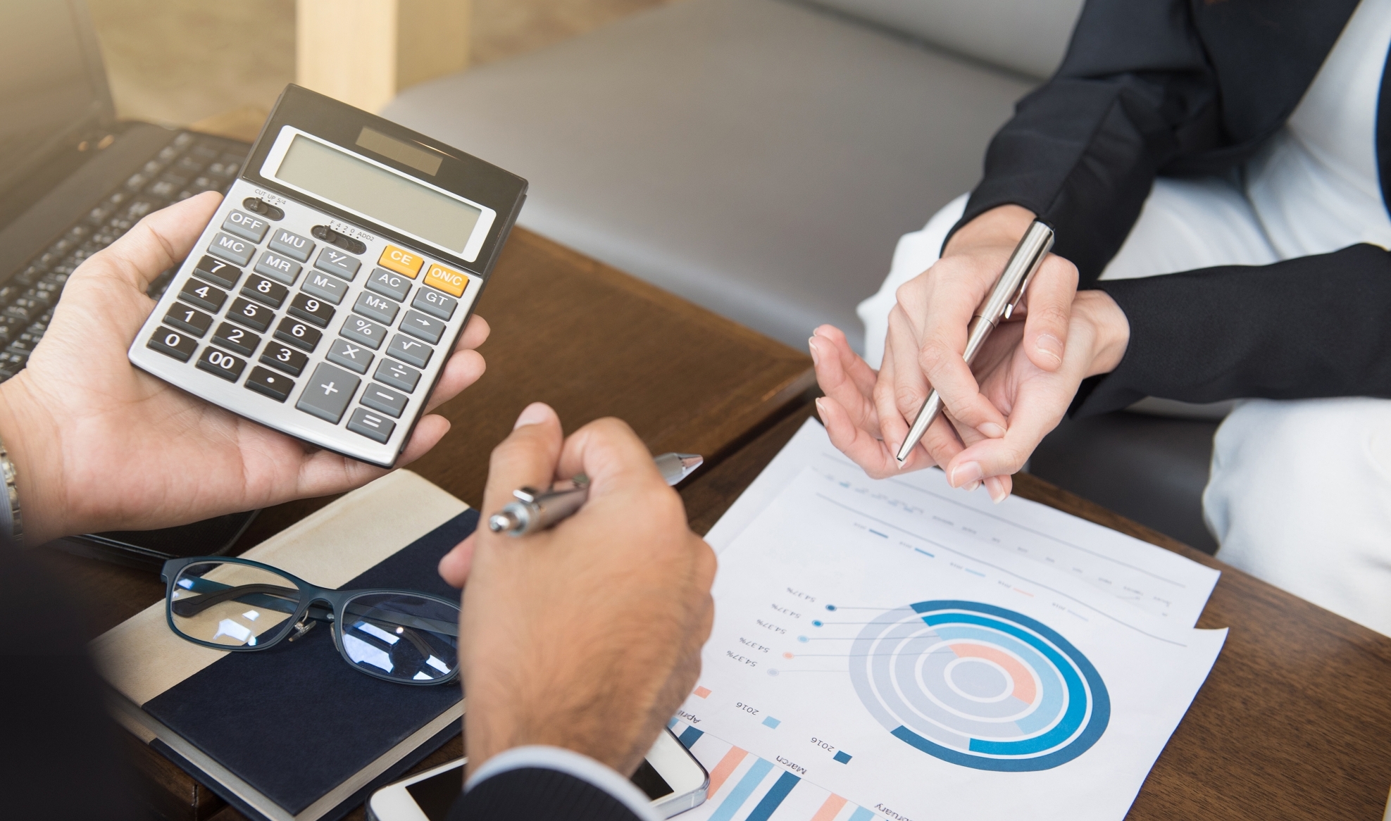 Business people calculating and discussing financial documents - financial assessment and evaluation concepts
