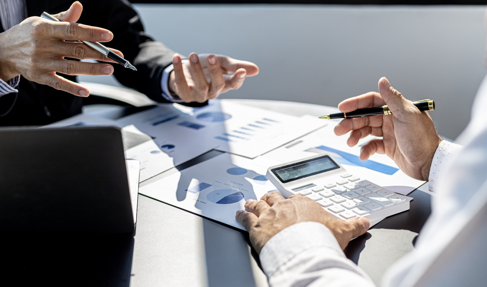 Meeting room atmosphere, business people meeting together on finance topics, they are working together to plan and solve corporate finance issues. Concept of business administration and finance.