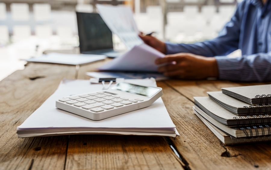 Close up view of bookkeeper or financial inspector hands making report, calculating or checking balance.